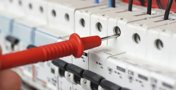 Electrical contractor testing circuit breakers during electrical repair in Fox Valley, IL