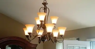 Classic ceiling chandelier installation with warm lighting in Naperville, IL