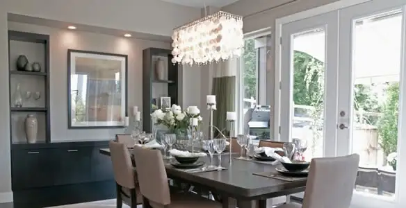 Elegant dining room chandelier installation above table in Naperville, IL