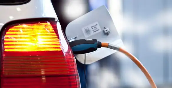 Electric car plugged into EV charger after professional installation in Naperville, IL