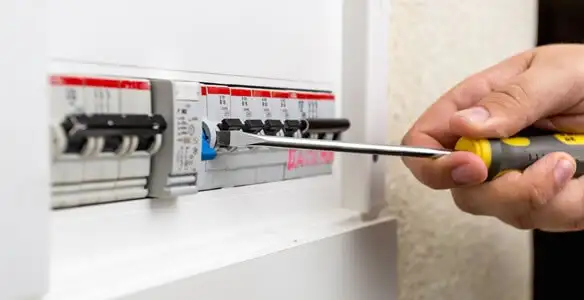 electrical panel upgrade service showing technician adjusting circuit breakers during system upgrade in Naperville, IL