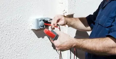 Electrician performing home electrical outlet and wiring inspection in Naperville, IL