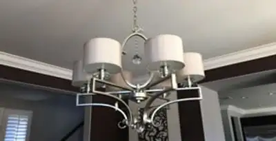 Modern chandelier installation with multiple light fixtures in Naperville, IL