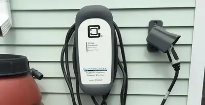 Outdoor electric vehicle charger installation on residential wall in Naperville, IL