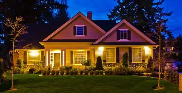 security light installation services illuminating a residential exterior at night in Naperville, IL