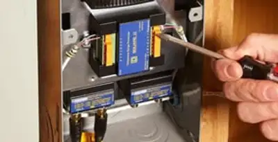 Whole home surge protection device being installed by a licensed electrician to protect electrical systems in Naperville, IL